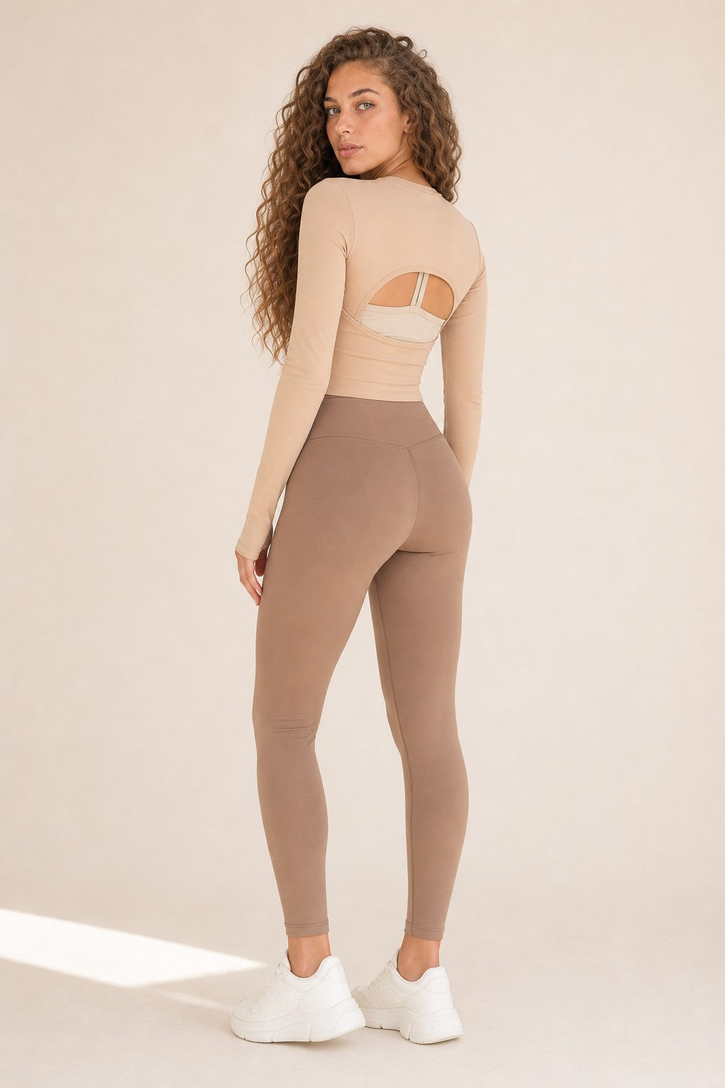 Model wearing NudeBlend Crew Neck Long Sleeve Top in Sand - back with open cut-out