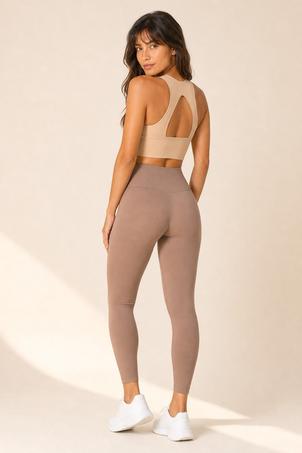 Model wearing NudeBlend Seamless Sports Bra in Sand - back with open cut-out