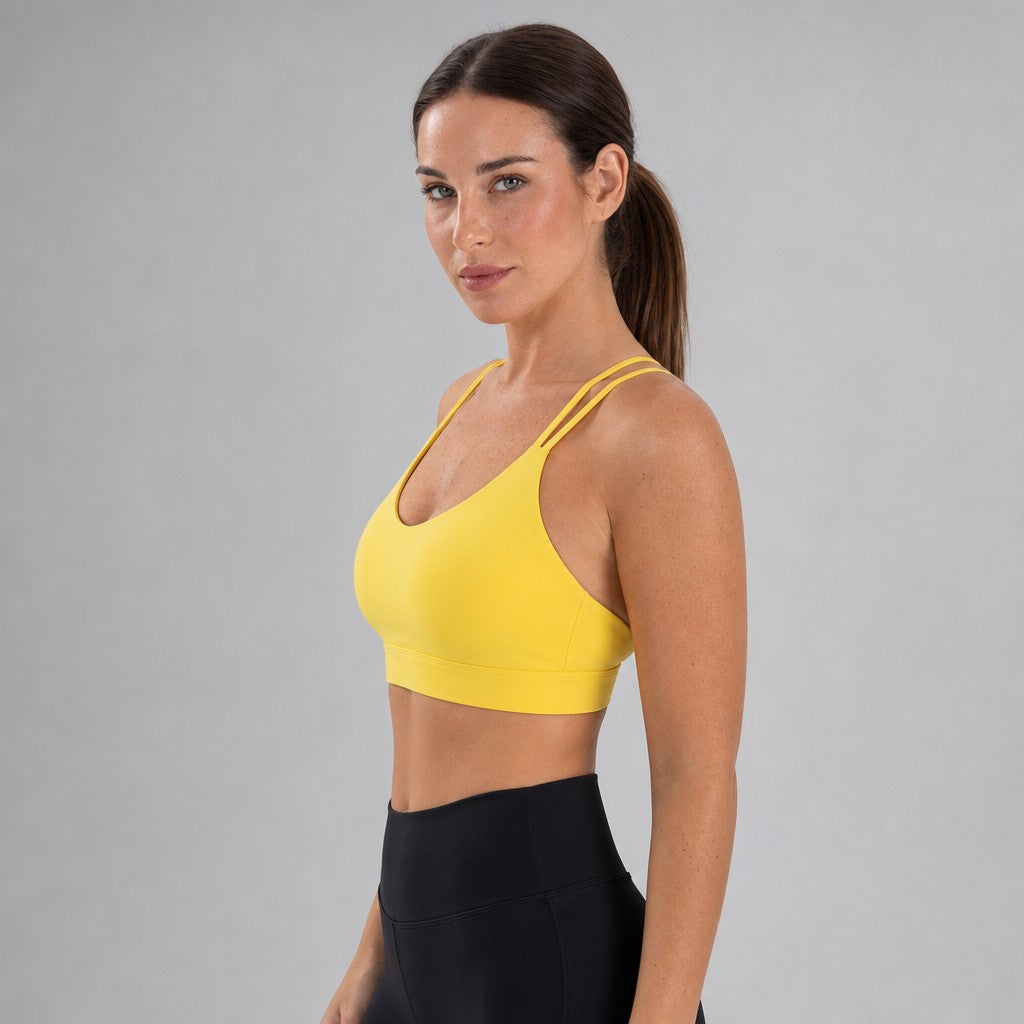 Model wearing NudeBlend Strappy Back Sports Bra in Yellow - side